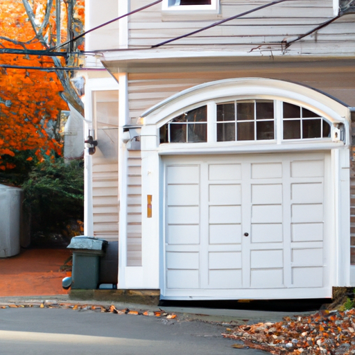 Brookline residential home with visible sectional garage door on a tree-lined street in fall light.